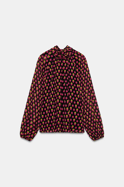 Printed shirt features a high neck polka dots